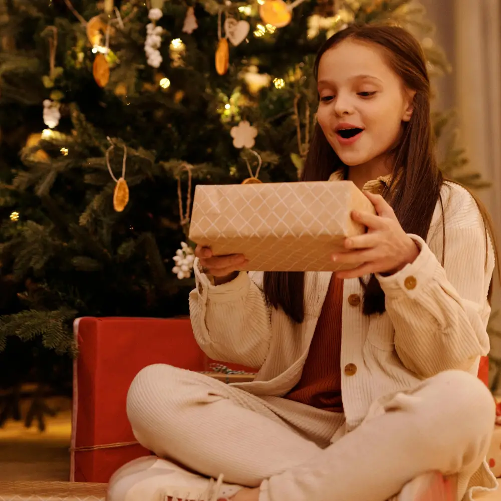 young girl holding gift